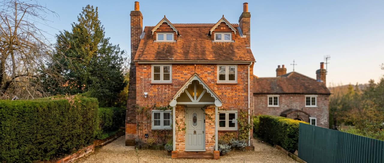A detailed view of painted Accoya bargeboards with decorative design on a traditional UK house roofl.